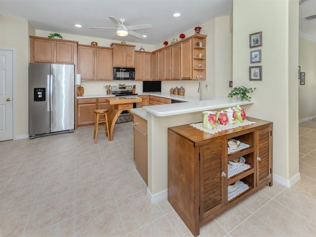 29704 Niagara Ct, Englewood, FL 34223 - kitchen featuring stainless steel appliances, open shelves, light countertops, a ceiling fan, and a peninsula