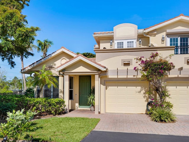 1164 Beachcomber Ct Unit 19, Osprey, FL 34229 - view of front of house featuring decorative driveway, an attached garage, and stucco siding