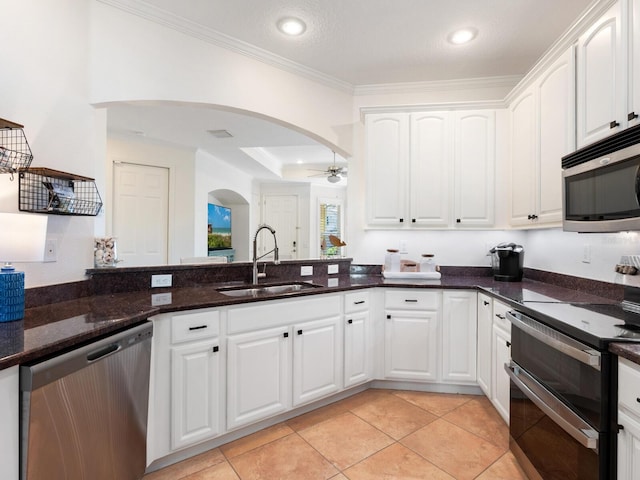 1164 Beachcomber Ct Unit 19, Osprey, FL 34229 - kitchen featuring appliances with stainless steel finishes, arched walkways, a ceiling fan, ornamental molding, and dark stone counters