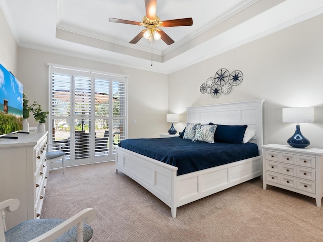 1164 Beachcomber Ct Unit 19, Osprey, FL 34229 - bedroom with light carpet, ornamental molding, access to exterior, a raised ceiling, and a ceiling fan