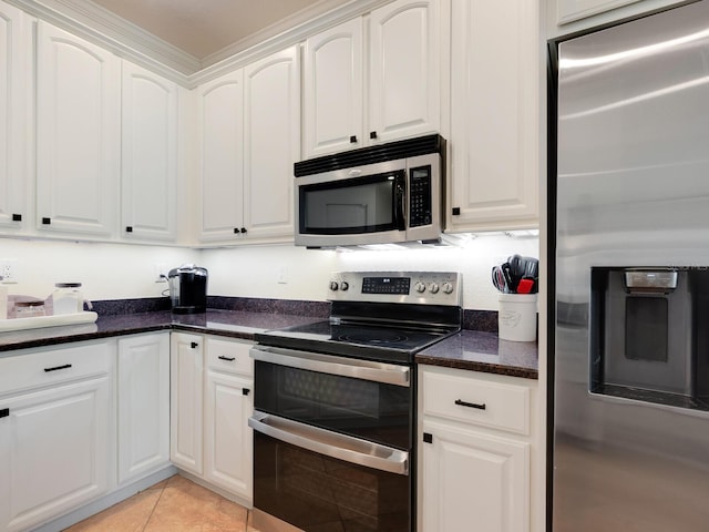 1164 Beachcomber Ct Unit 19, Osprey, FL 34229 - kitchen with stainless steel appliances, white cabinets, dark stone counters, and light tile patterned flooring