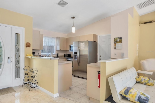 2445 Apache St, Sarasota, FL 34231 - kitchen with stainless steel appliances, a peninsula, vaulted ceiling, and light countertops