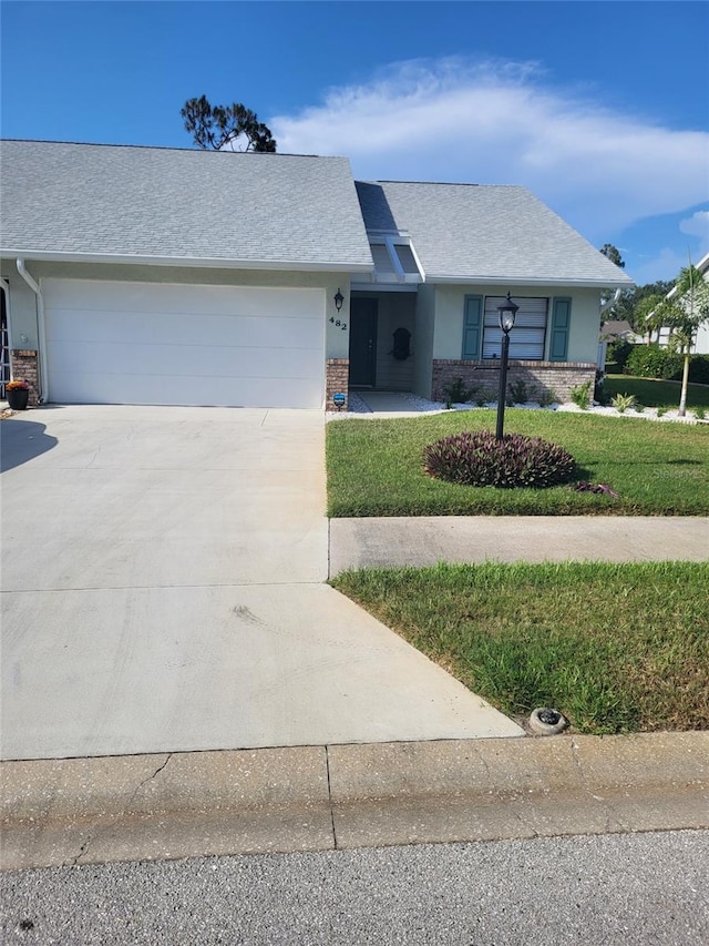 482 Pendleton Pl, Venice, FL 34292 - view of front of house featuring a garage, driveway, a front yard, and a shingled roof