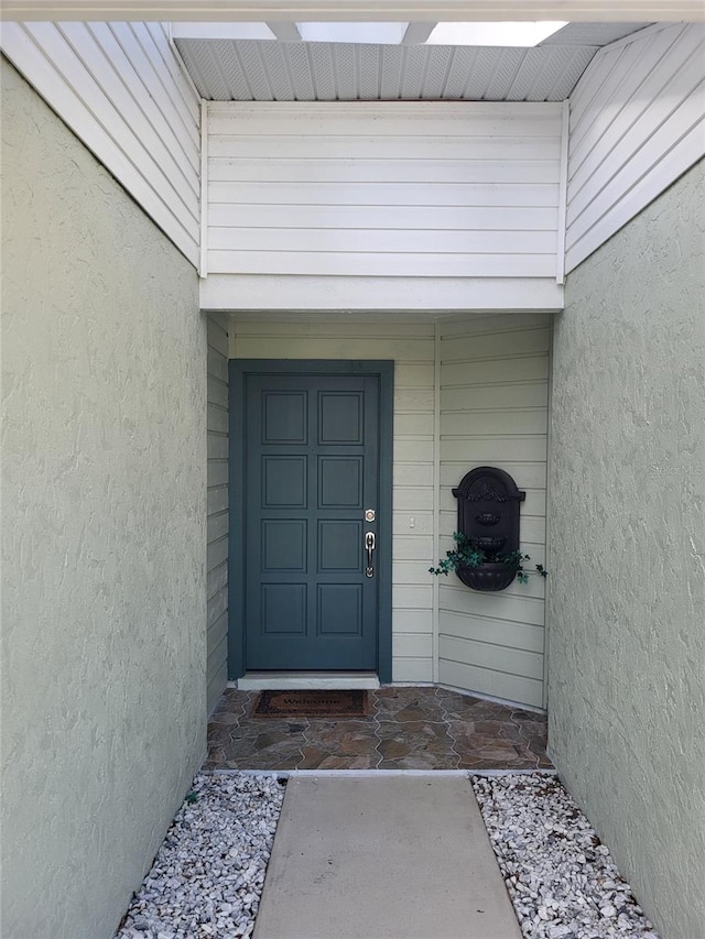 482 Pendleton Pl, Venice, FL 34292 - doorway to property with stucco siding