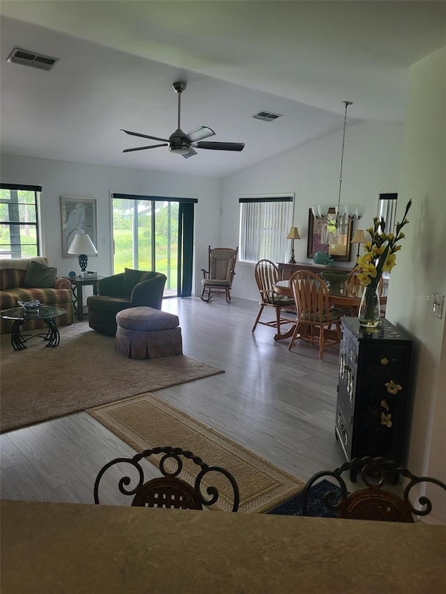 482 Pendleton Pl, Venice, FL 34292 - living room with wood finished floors, vaulted ceiling, ceiling fan, and a chandelier