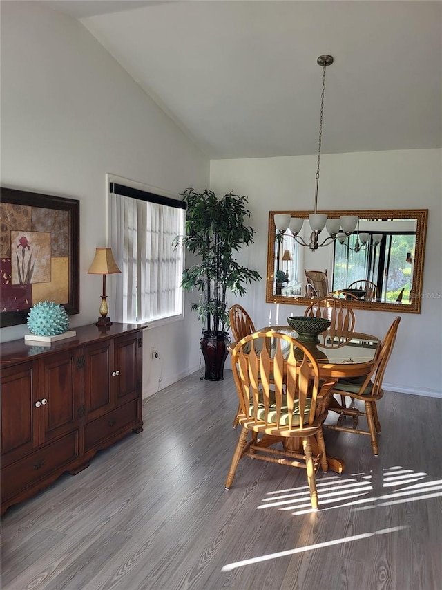 482 Pendleton Pl, Venice, FL 34292 - dining space with vaulted ceiling, light wood finished floors, and a chandelier
