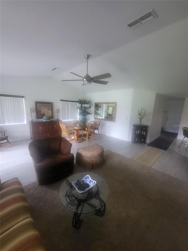 482 Pendleton Pl, Venice, FL 34292 - living area featuring vaulted ceiling, a ceiling fan, and carpet flooring