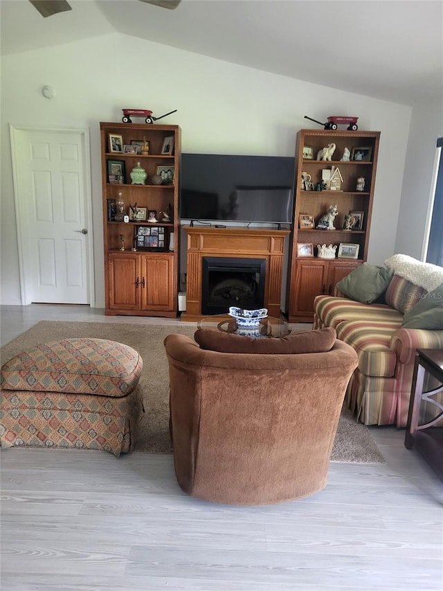 482 Pendleton Pl, Venice, FL 34292 - living area featuring vaulted ceiling, a fireplace, and light wood finished floors