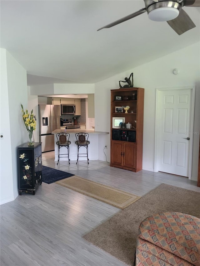 482 Pendleton Pl, Venice, FL 34292 - living area featuring a ceiling fan, light wood-style flooring, and lofted ceiling