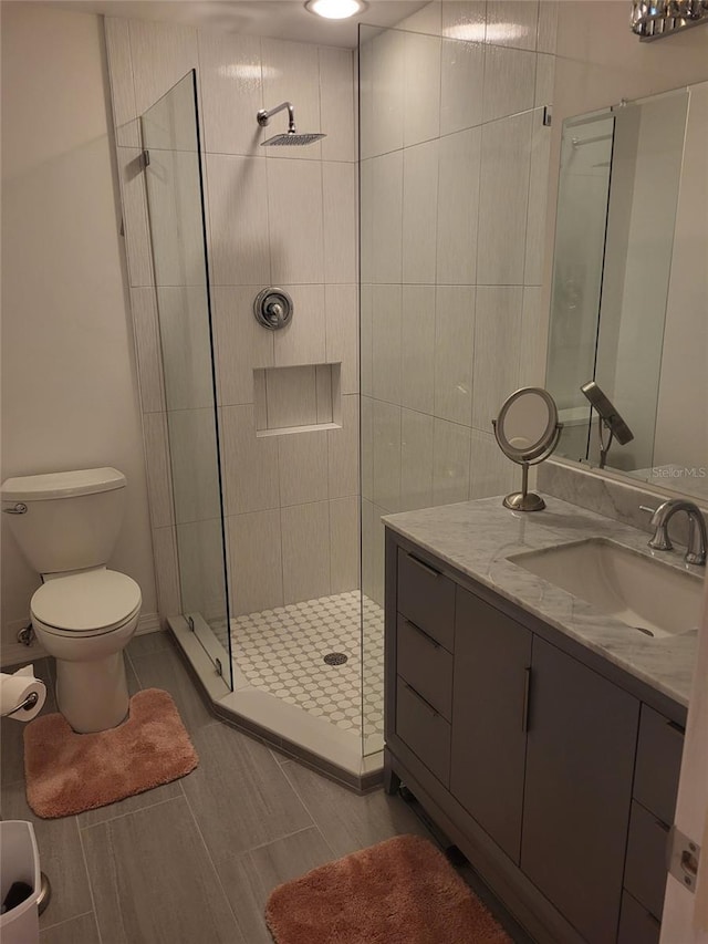 482 Pendleton Pl, Venice, FL 34292 - bathroom with vanity, a shower stall, and wood finish floors