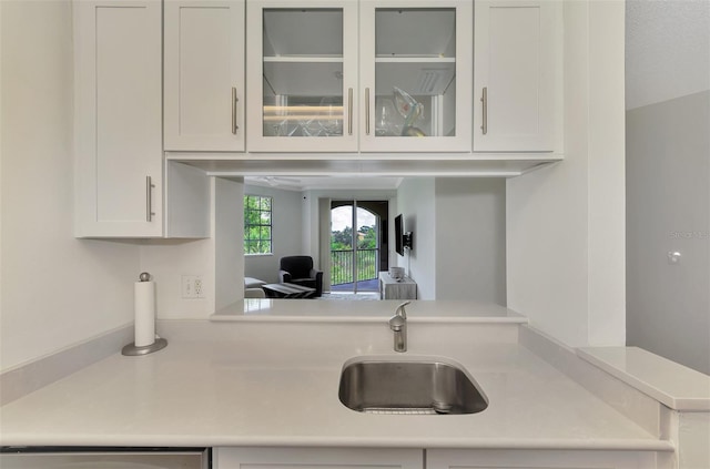 5459 Bentgrass Dr Unit 2-304, Sarasota, FL 34235 - kitchen with light countertops, white cabinets, glass insert cabinets, and dishwasher