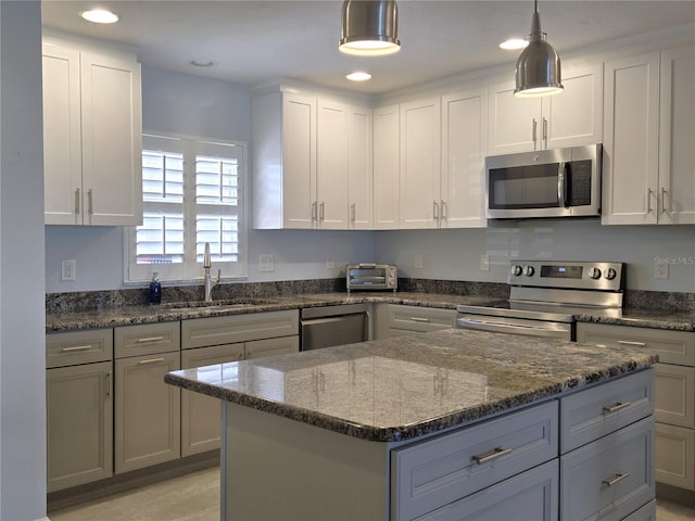 333 The Esplanade N Unit 102, Venice, FL 34285 - kitchen with appliances with stainless steel finishes, dark stone counters, pendant lighting, recessed lighting, and a kitchen island
