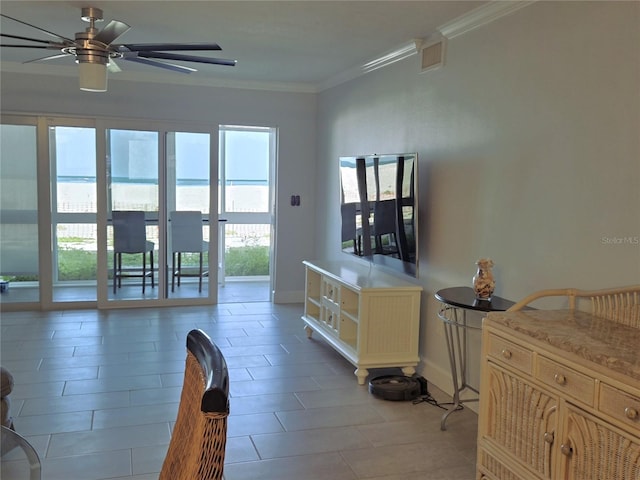 333 The Esplanade N Unit 102, Venice, FL 34285 - living room featuring a ceiling fan, crown molding, and light tile patterned floors