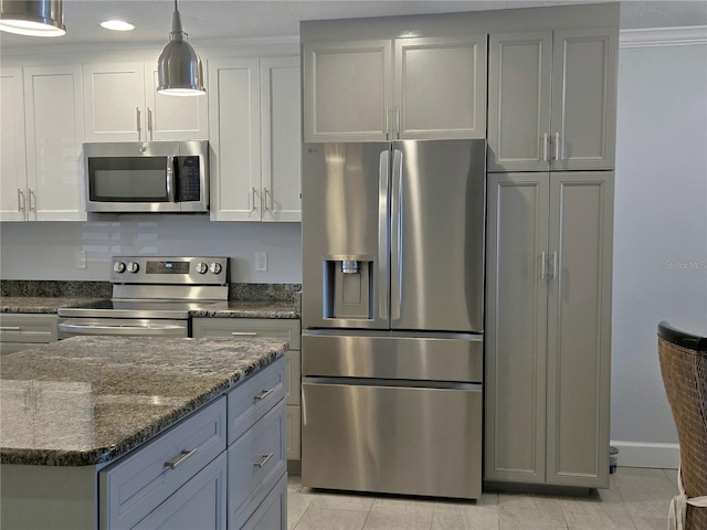 333 The Esplanade N Unit 102, Venice, FL 34285 - kitchen with stainless steel appliances, light tile patterned floors, dark stone counters, decorative light fixtures, and recessed lighting