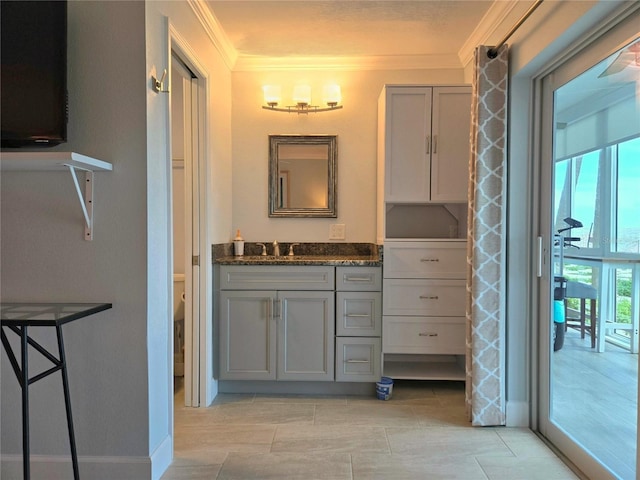 333 The Esplanade N Unit 102, Venice, FL 34285 - bathroom featuring ornamental molding, vanity, and plenty of natural light