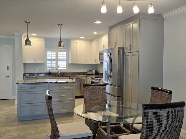 333 The Esplanade N Unit 102, Venice, FL 34285 - kitchen with appliances with stainless steel finishes, ornamental molding, white cabinets, recessed lighting, and dark stone countertops