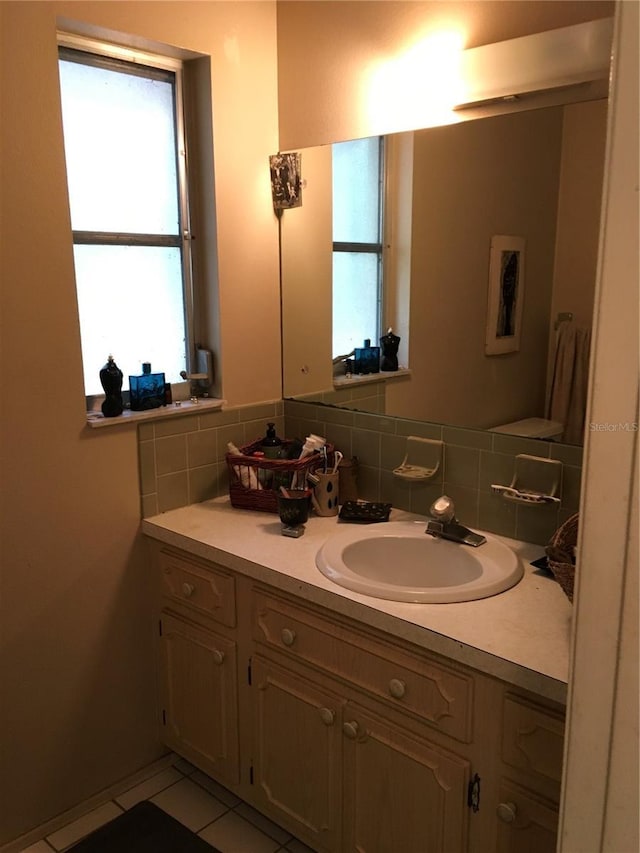 3661 Sterling Rd, Venice, FL 34293 - bathroom with vanity, decorative backsplash, and tile patterned flooring