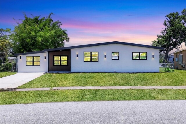 6821 Marius Rd, North Port, FL 34287 - view of front of property featuring a front lawn and stucco siding