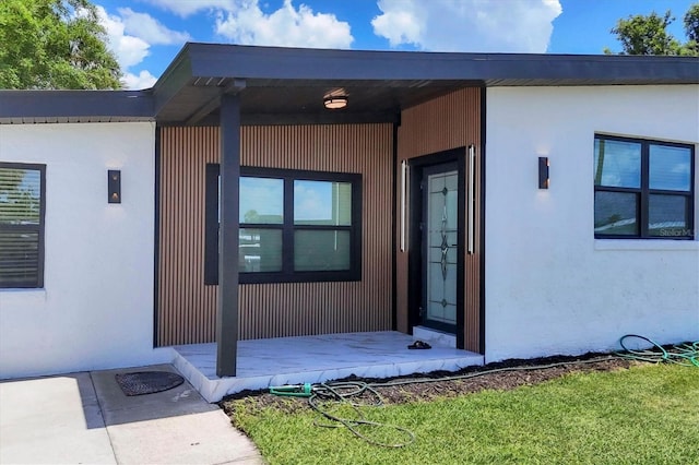 6821 Marius Rd, North Port, FL 34287 - entrance to property featuring stucco siding