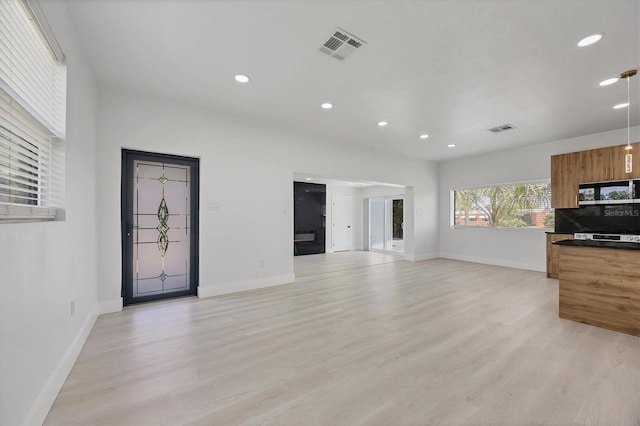6821 Marius Rd, North Port, FL 34287 - unfurnished living room with recessed lighting and light wood finished floors