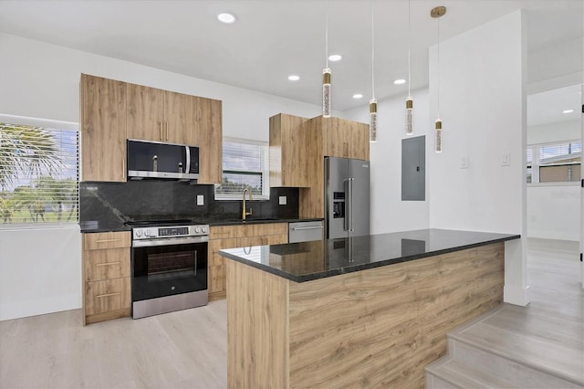 6821 Marius Rd, North Port, FL 34287 - kitchen featuring appliances with stainless steel finishes, electric panel, light wood-style flooring, modern cabinets, and healthy amount of natural light