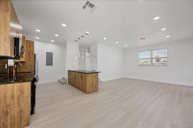 6821 Marius Rd, North Port, FL 34287 - kitchen featuring electric panel, modern cabinets, a kitchen island, light wood finished floors, and brown cabinets