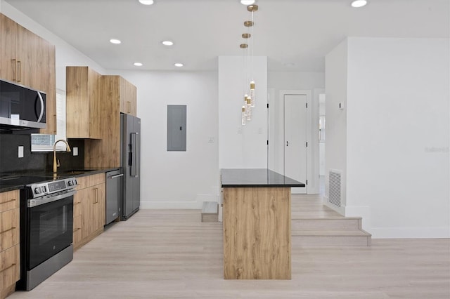 6821 Marius Rd, North Port, FL 34287 - kitchen featuring appliances with stainless steel finishes, modern cabinets, electric panel, light wood-type flooring, and recessed lighting