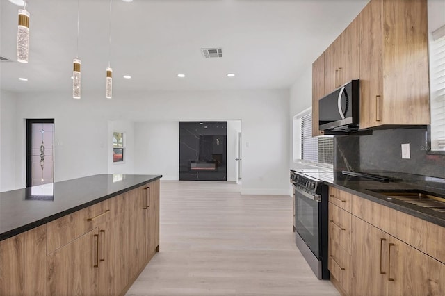 6821 Marius Rd, North Port, FL 34287 - kitchen with stainless steel microwave, modern cabinets, dark countertops, and recessed lighting