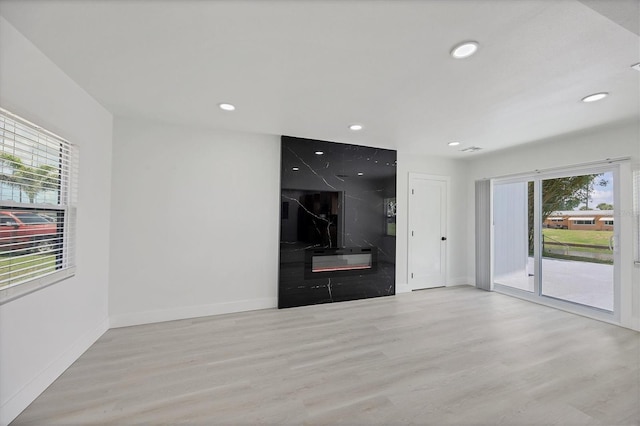6821 Marius Rd, North Port, FL 34287 - unfurnished living room featuring healthy amount of natural light, wood finished floors, and recessed lighting