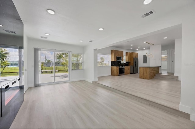 6821 Marius Rd, North Port, FL 34287 - unfurnished living room featuring electric panel, light wood-style floors, and recessed lighting