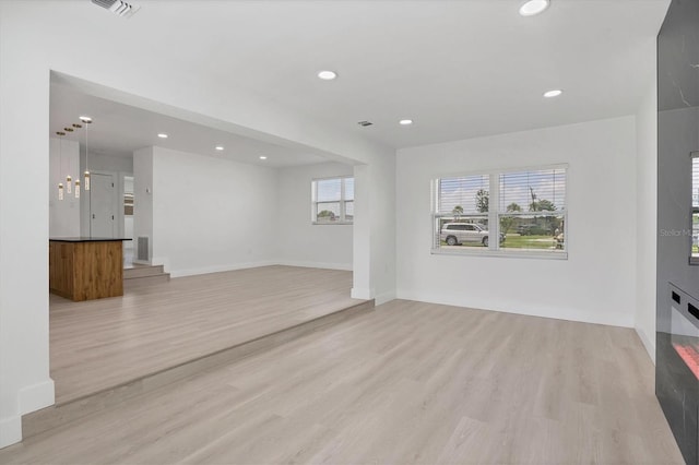 6821 Marius Rd, North Port, FL 34287 - unfurnished living room with light wood-style floors and recessed lighting