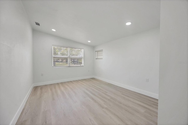6821 Marius Rd, North Port, FL 34287 - empty room with light wood finished floors, recessed lighting, and lofted ceiling