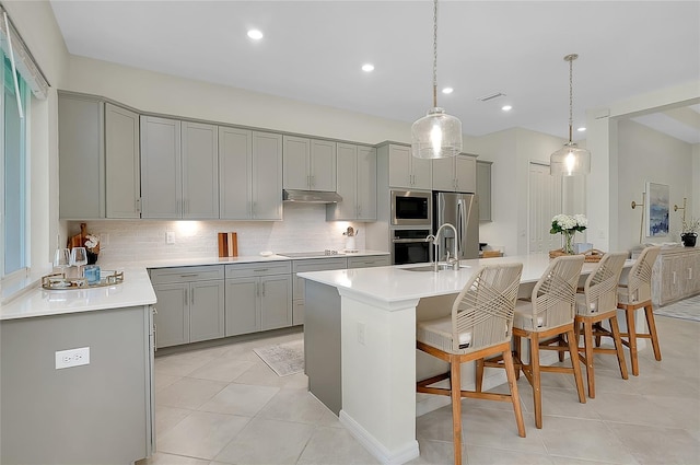 17525 Jadestone Ct, Venice, FL 34293 - kitchen with gray cabinetry, appliances with stainless steel finishes, light tile patterned floors, backsplash, and recessed lighting