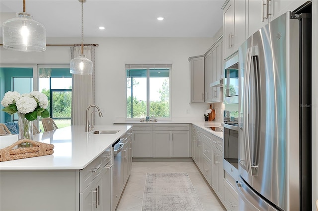 17525 Jadestone Ct, Venice, FL 34293 - kitchen with appliances with stainless steel finishes, gray cabinetry, healthy amount of natural light, and recessed lighting