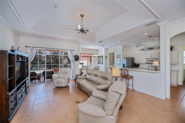 4308 Via Del Santi, Venice, FL 34293 - living room featuring ceiling fan, a raised ceiling, light tile patterned floors, ornamental molding, and arched walkways