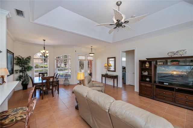 4308 Via Del Santi, Venice, FL 34293 - living room with light tile patterned flooring, ornamental molding, a chandelier, and ceiling fan