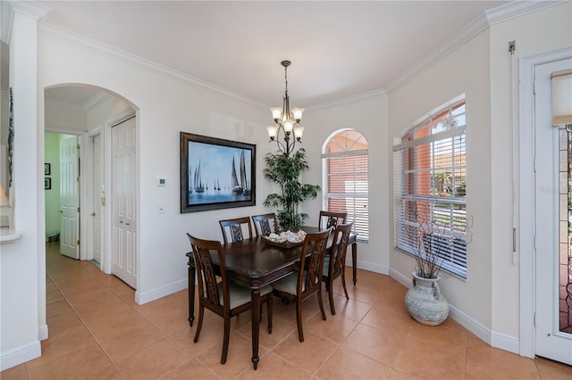 4308 Via Del Santi, Venice, FL 34293 - dining space featuring a chandelier, arched walkways, ornamental molding, and light tile patterned floors