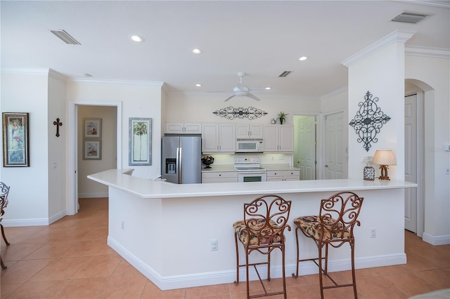4308 Via Del Santi, Venice, FL 34293 - kitchen with white appliances, ceiling fan, arched walkways, light tile patterned floors, and light countertops