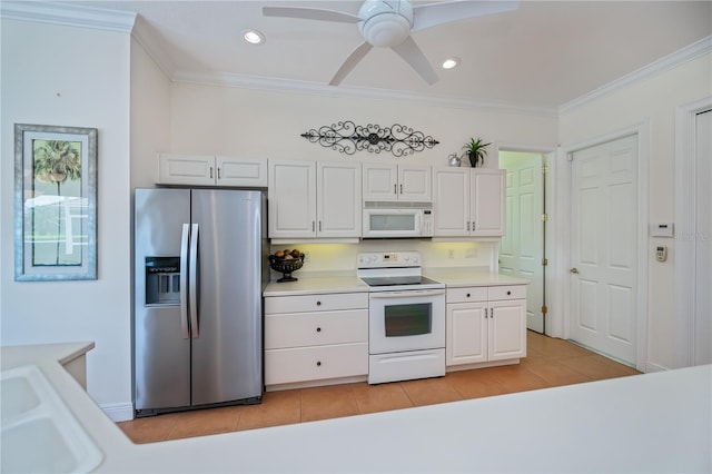 4308 Via Del Santi, Venice, FL 34293 - kitchen with white appliances, white cabinets, light tile patterned flooring, light countertops, and crown molding