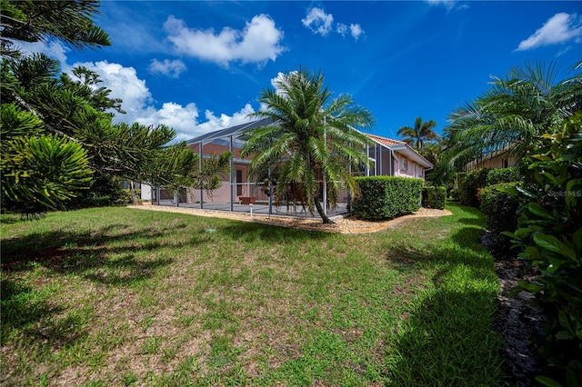 4308 Via Del Santi, Venice, FL 34293 - view of grassy yard with a patio and glass enclosure