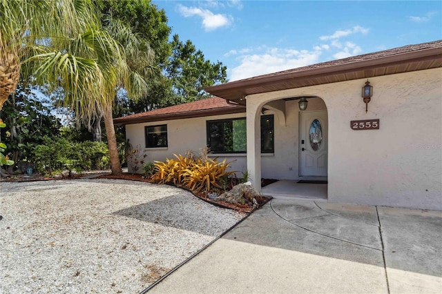 2555 Yucca Rd, Venice, FL 34293 - doorway to property featuring stucco siding