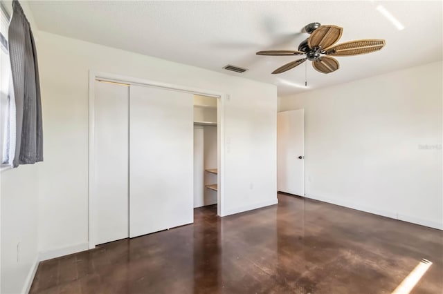 2555 Yucca Rd, Venice, FL 34293 - unfurnished bedroom featuring concrete floors, a closet, and a ceiling fan