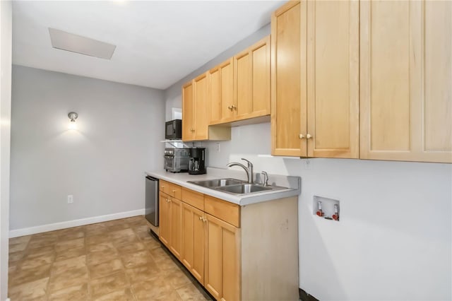 2555 Yucca Rd, Venice, FL 34293 - kitchen with light brown cabinetry, light countertops, and dishwasher