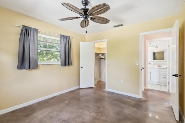2555 Yucca Rd, Venice, FL 34293 - unfurnished bedroom featuring concrete floors, a walk in closet, and a closet