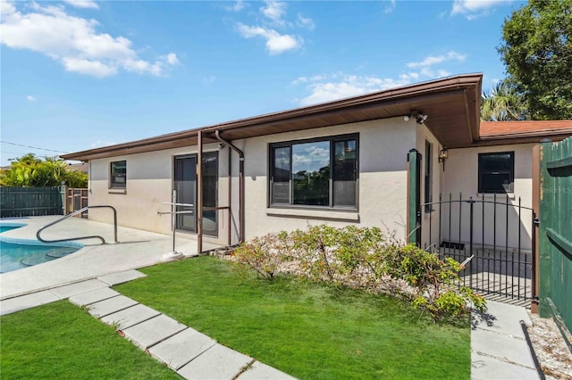 2555 Yucca Rd, Venice, FL 34293 - back of house with stucco siding and a patio