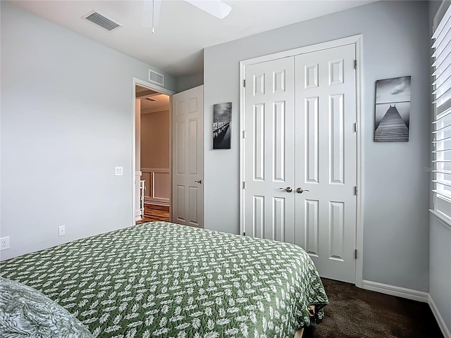 20749 Swallowtail Ct, Venice, FL 34293 - bedroom with dark colored carpet, a closet, multiple windows, and ceiling fan