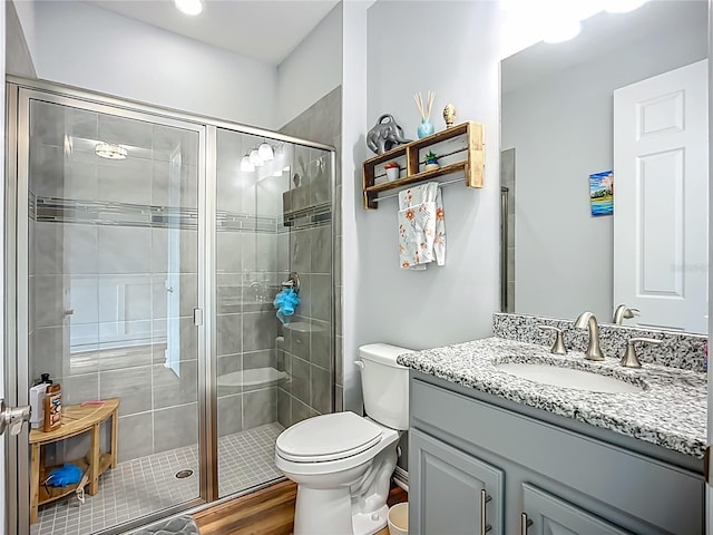 20749 Swallowtail Ct, Venice, FL 34293 - full bathroom with vanity, a shower stall, and wood finished floors