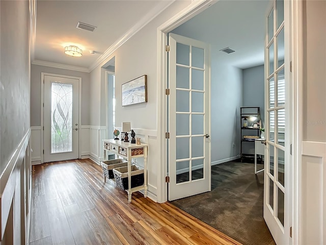20749 Swallowtail Ct, Venice, FL 34293 - foyer with french doors, a decorative wall, ornamental molding, a wainscoted wall, and wood finished floors