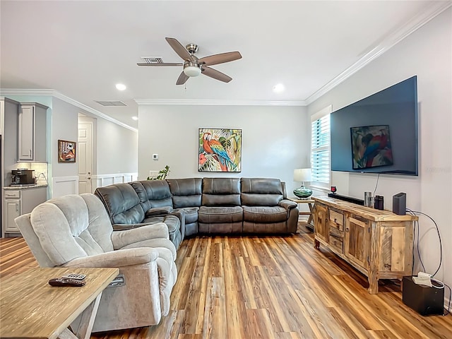 20749 Swallowtail Ct, Venice, FL 34293 - living room featuring light wood-style flooring, ornamental molding, a ceiling fan, and recessed lighting