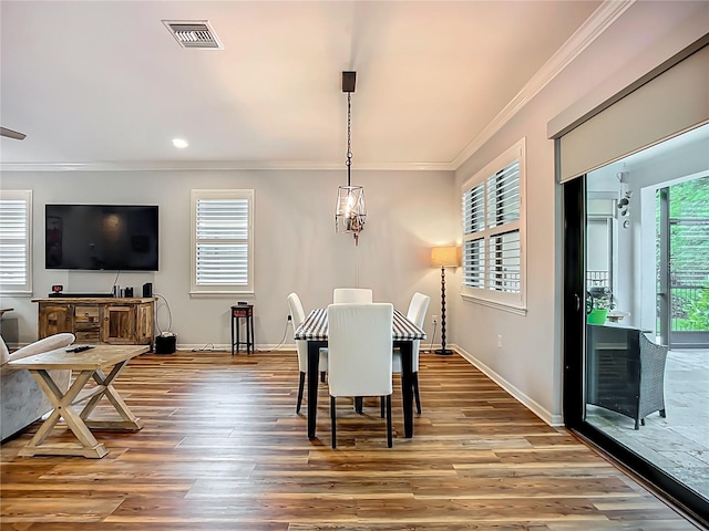 20749 Swallowtail Ct, Venice, FL 34293 - dining area featuring ornamental molding, wood finished floors, and recessed lighting